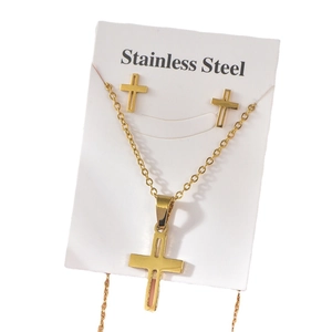 Golden stainless steel jewelry set featuring a cross pendant necklace and stud earrings