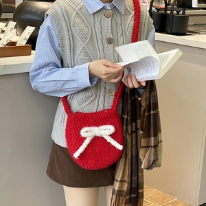 Red teddy fleece bucket bag with white knit bow and crossbody strap for women