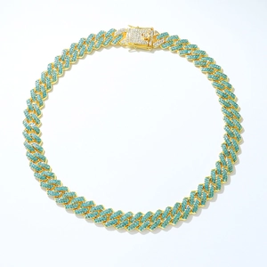Detailed close-up of gold-plated Cuban chain necklace featuring blue micro-pave crystals