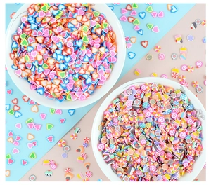 Macro view of colorful 5mm heart and dessert polymer clay slices in white bowls