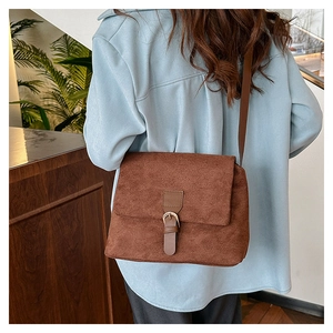 Retro brown faux suede tote bag with metal buckle shown in a stylish crossbody wear