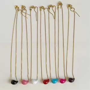 Detailed row of colorful teardrop pendants on gold stainless steel link chains