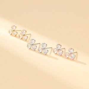 Macro view of heart-cut zircon clover stud earrings with elegant silver base finish