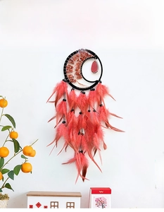 Detail of tree of life dreamcatcher with pink agate slice and coral feathers