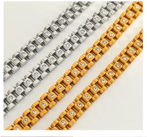 Detailed close-up of watchband link bracelet with gold and silver finish and zircons
