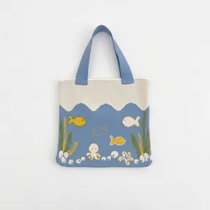 Close-up of ocean-themed knitted tote bag with blue octopus and sea creature patterns