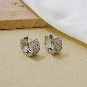 Detail of silver hoop earrings featuring multi-row pave setting with sparkling zircons