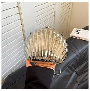 Silver shell-shaped clutch bag with metallic finish and thin chain shoulder strap