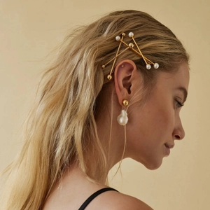 Elegant gold geometric hair pins with pearls and baroque pearl earring on blonde hair