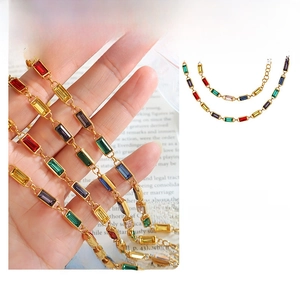 Detail of luxury gold bracelet with colorful rectangular cubic zirconia and gems