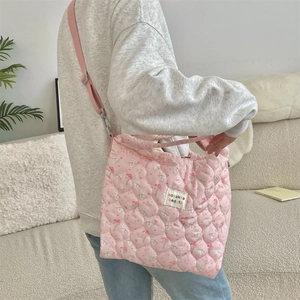 Quilted pink crossbody bag with cute rabbit print shown from a stylish back view angle