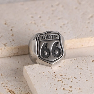 Vintage silver Route 66 stainless steel ring for men on a professional stone background