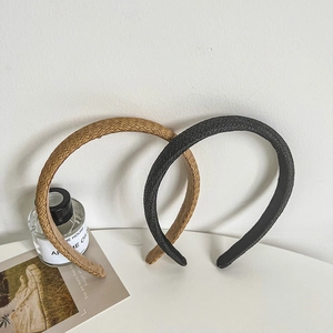 Set of two handmade woven headbands in brown and black colors with a minimalist straw texture