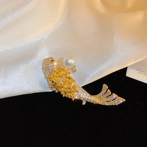 Golden koi fish brooch with yellow zircon and white pearl on premium champagne silk