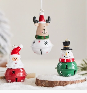 Close-up of metal Christmas bell ornaments with Santa, elk, and snowman figures