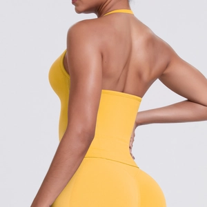 Detail view of yellow halter sports bra and high-waist leggings with backless design