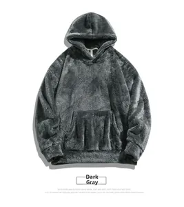 Close-up of thick dark grey fleece hoodie showing plush texture and front kangaroo pocket