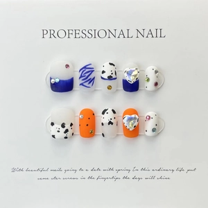 Detailed view of handmade press-on nails featuring blue and orange sets with crystal hearts