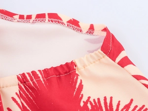 Detailed close-up showing reinforced stitching and coconut tree print on polyester fabric