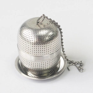 Detail of 304 stainless steel tea infuser ball with fine mesh, chain, and base tray