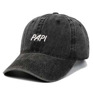 Close-up of vintage washed dark gray baseball cap with 3D white PAPI letter embroidery