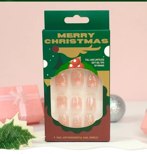 Detail view of Christmas snowflake soft gel nail tips in festive green packaging box