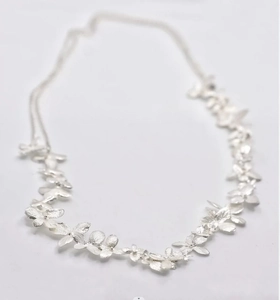 Detailed view of handmade adjustable silver flower necklace with metallic floral links