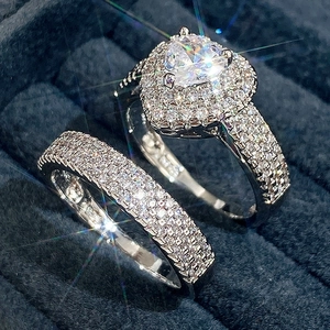Silver-colored heart zircon bridal set with main ring and matching band on velvet