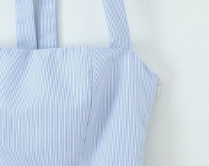 Detail of blue and white striped fabric showing the side invisible zipper and fine texture