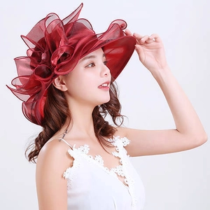 Detail of elegant wine red organza hat with large dimensional floral bow decoration