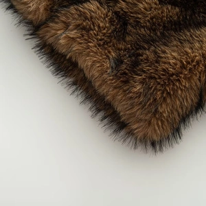 Close-up of high-density long faux fur material in deep brown and black tones