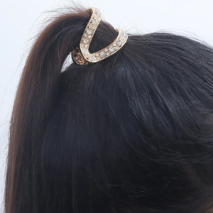 Elegant gold V-shaped ponytail hair clip with rhinestones for high bun styling