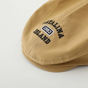 Khaki cotton beret hat with 1983 embroidery for kids, front view on grey background