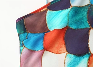 Close-up of neat stitching and vibrant colorful print fabric on a sleeveless dress