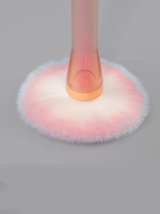 Detail of soft gradient pink and blue bristles on a loose powder makeup brush
