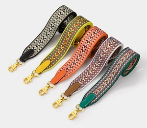 Detailed view of five embroidered wide shoulder straps with geometric arrow patterns