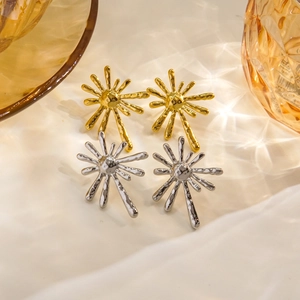 Radial sunburst 14K gold and silver stainless steel earrings on a soft fabric