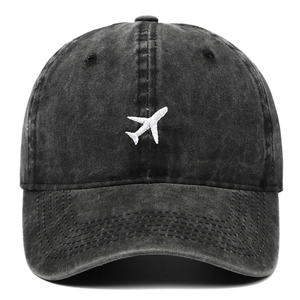 Vintage charcoal grey cotton baseball cap with white airplane embroidery on a white background