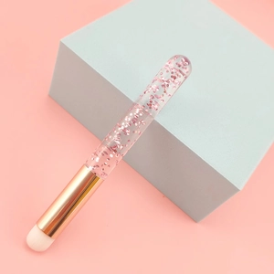 Detail of round head lip brush with pink glitter handle and soft white bristles