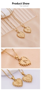 Detail of gold heart pendant necklace featuring textured surface and embossed letter A