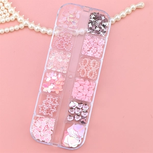 Pink butterfly and flower resin nail art charms in a 12-slot clear storage box