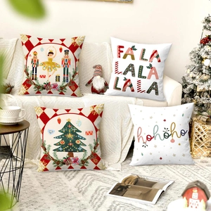 Set of 4 festive Christmas pillow covers with holiday patterns on a cozy beige sofa