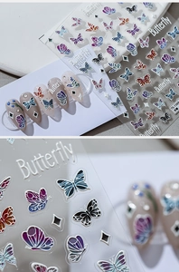 Macro detail of 5D embossed butterfly nail art stickers with textured 3D floral patterns