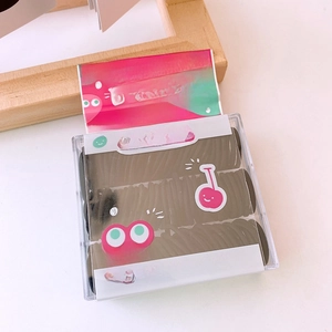 Detail of boxed black high-elastic hair ties for babies in a clear plastic case