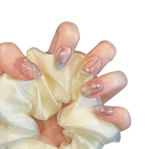 Handmade gradient press-on nails with shimmering pink glitter, pearls, and crystals