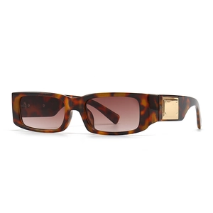 Modern rectangular tortoiseshell sunglasses with distinctive gold metal hinge accents