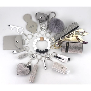 Detailed macro view of gray and silver self-defense keychain set with rhinestone accessories
