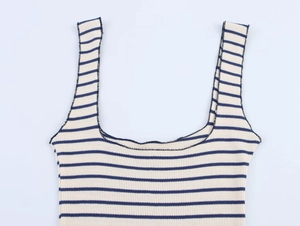 Close-up of knit fabric texture on cream and navy striped camisole dress neck