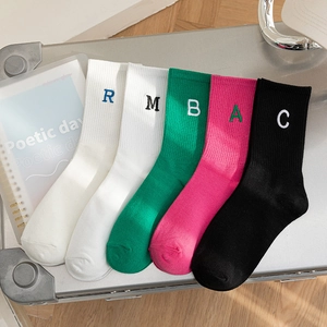 Five pairs of cotton mid-calf socks with letter embroidery on a metallic surface