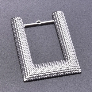Macro detail of silver geometric U-link connector with hammer texture for jewelry DIY